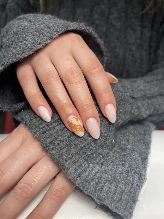Almond nude gel manicure with a hand-painted accent nail