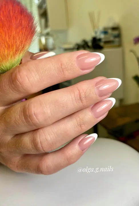 Classic white French tips on almond nails
