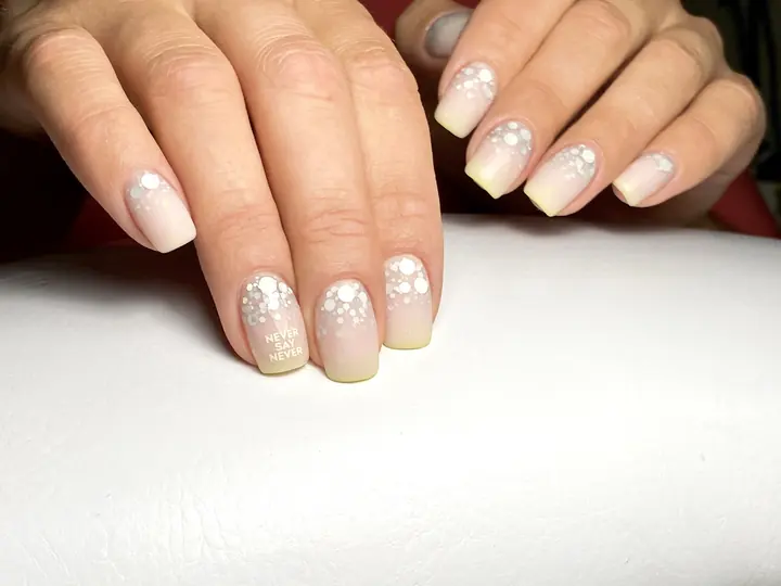 Soft nude manicure with white dot design