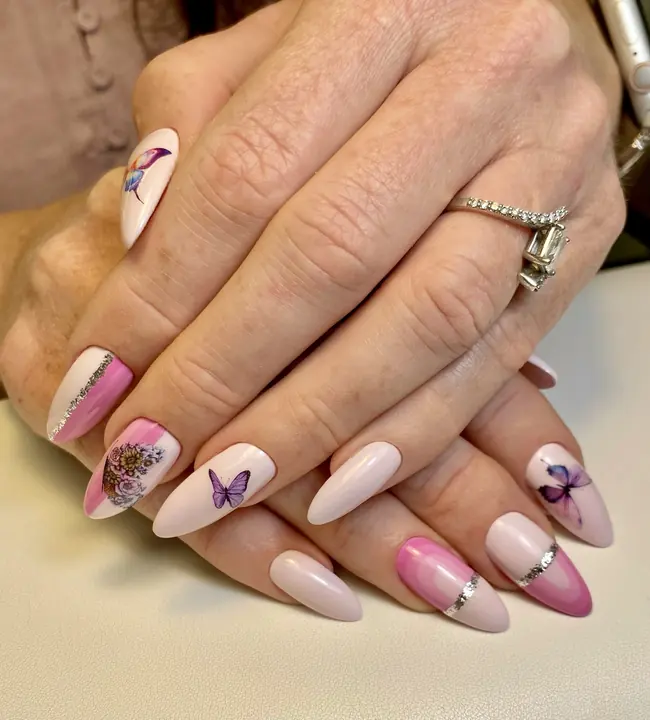 Nude almond nails with butterfly art and chrome bands