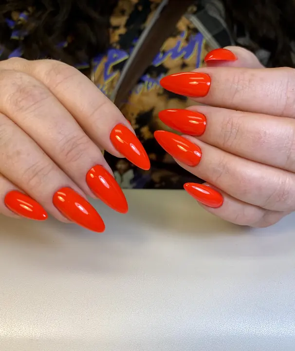 Bright red-orange stiletto gel extensions