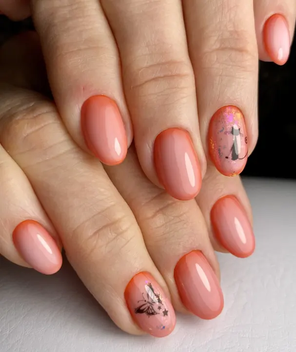 Peach gel manicure with a painted butterfly