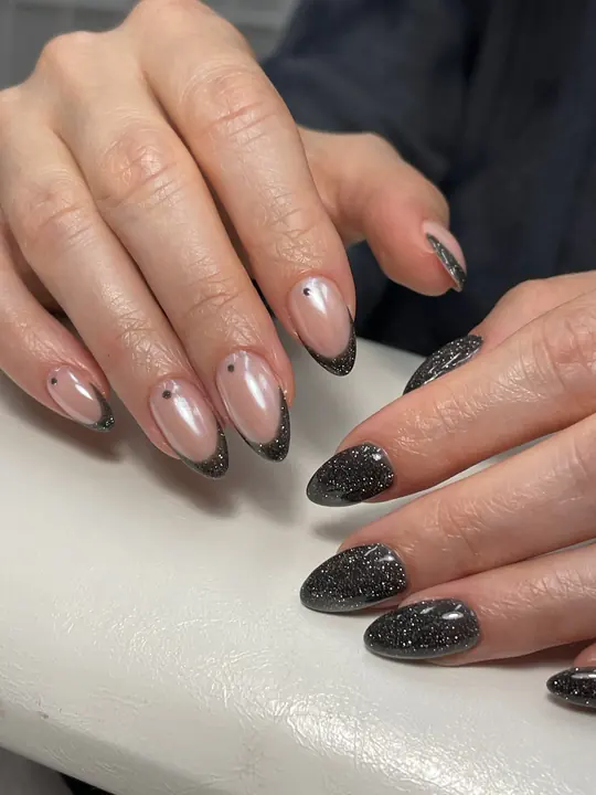 Black glitter French tips on almond nails