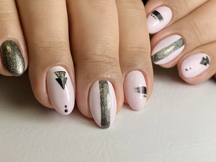 Pale pink manicure with silver geometric art