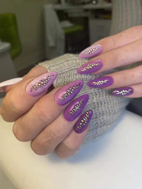 Purple almond nails with crystal accents