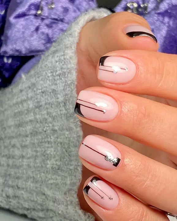 Pale pink manicure with black and silver line art