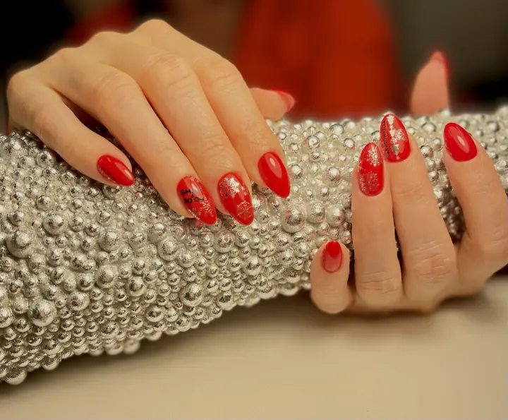Red almond nails with glitter accents