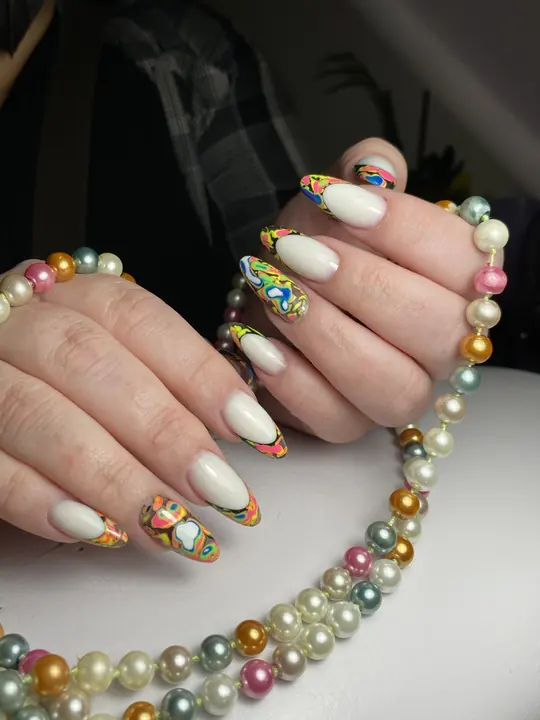 Hand-painted multicolor art on milky almond nails