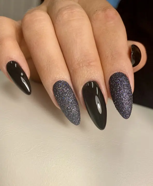 Long black almond nails with sparkle finish