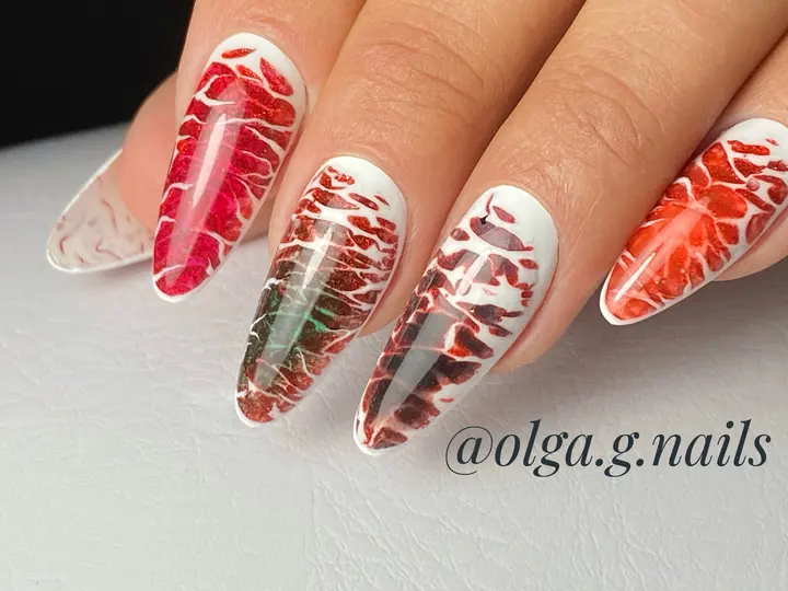 Red and white flame design on long almond nails