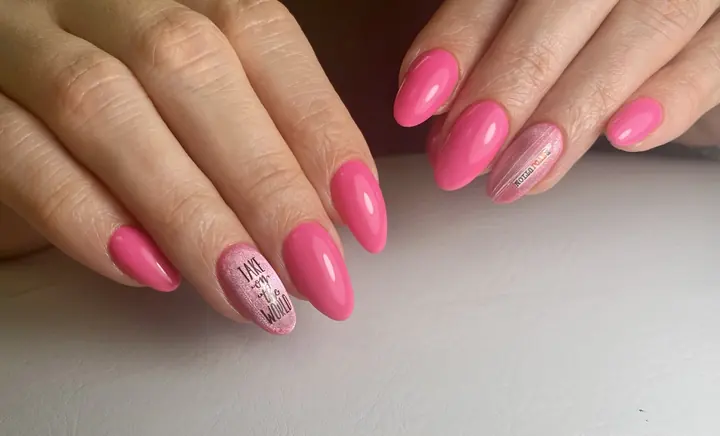 Hot pink manicure with a lettering accent nail
