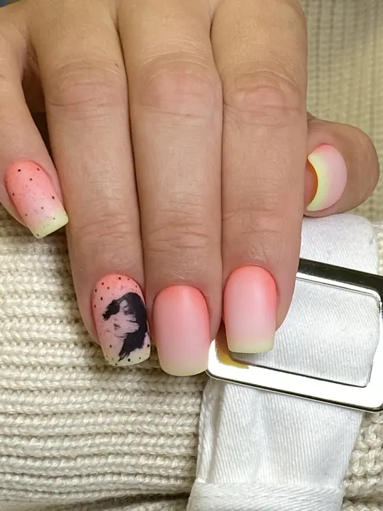 Peach ombre manicure with portrait art accent