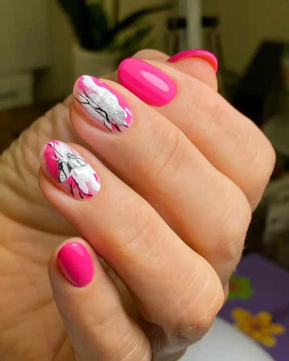 Hot pink manicure with painted white flowers