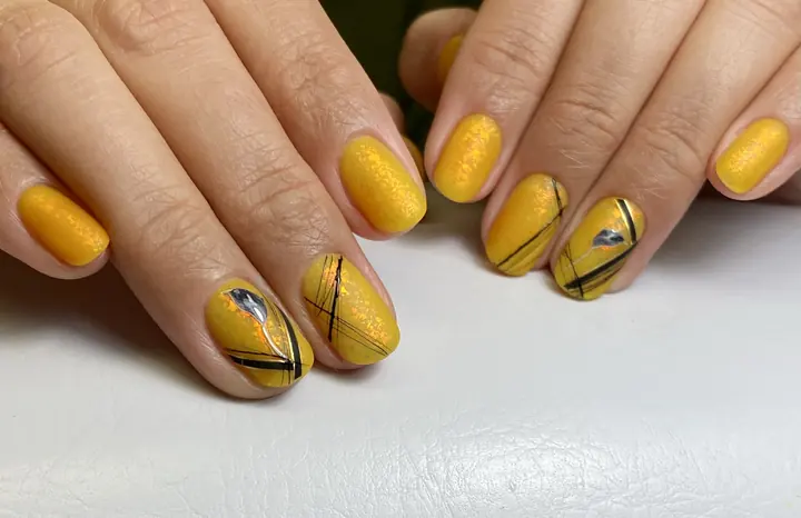 Mustard manicure with black line accents