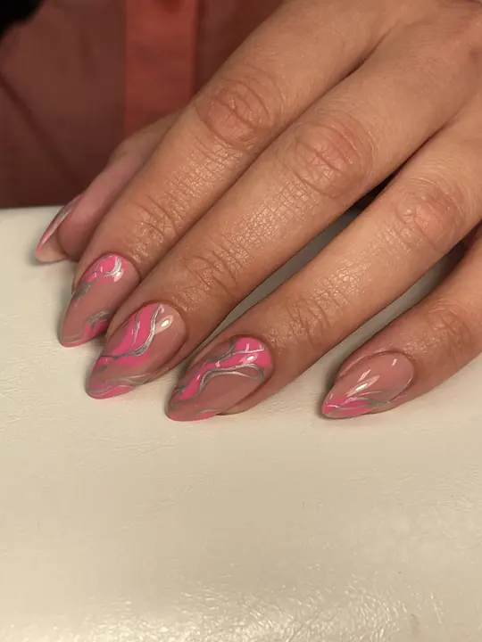 Nude almond nails with pink swirl design