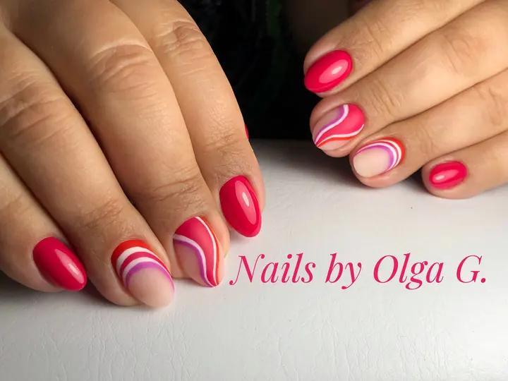 Red and pink manicure with swirl accents