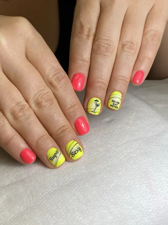 Coral and yellow manicure with lettering art