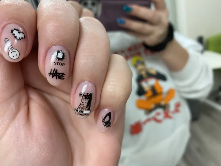 Nude manicure with black illustrated accent nails