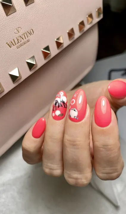 Coral almond nails with painted floral accents