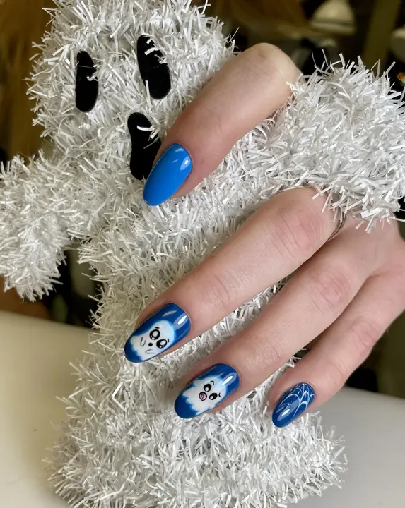 Cobalt blue almond nails with playful ghost art
