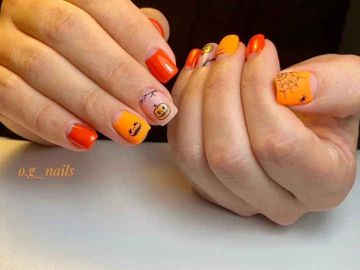 Orange manicure with Halloween pumpkin art
