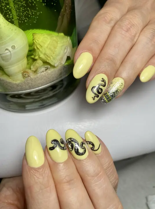 Pastel yellow almond nails with hand-painted art