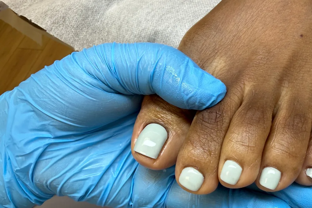 Soft sage gel pedicure with clean, square-shaped toenails